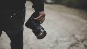 image of someone holding a camera in right hand