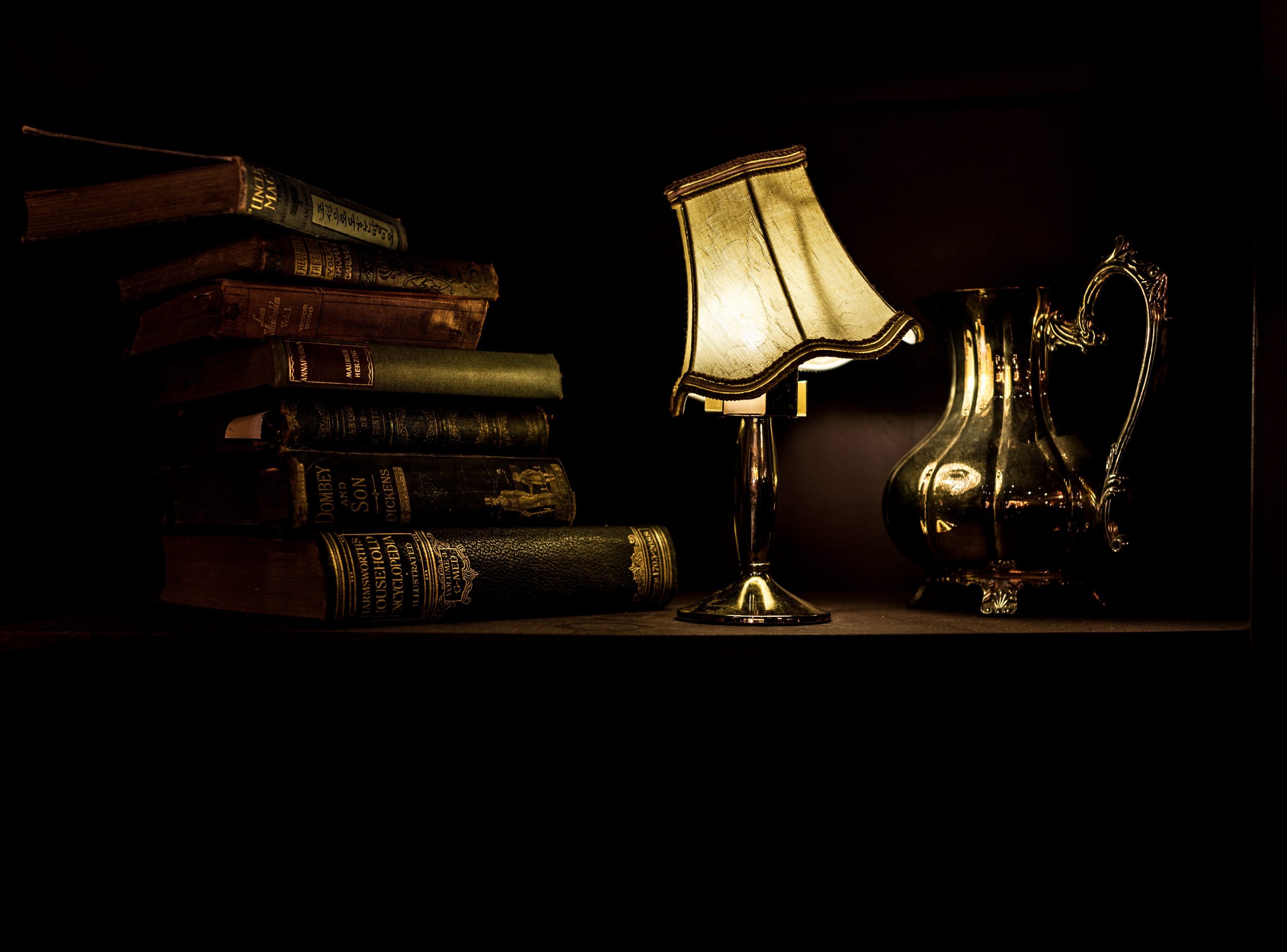 image of antique lamp and pile of books
