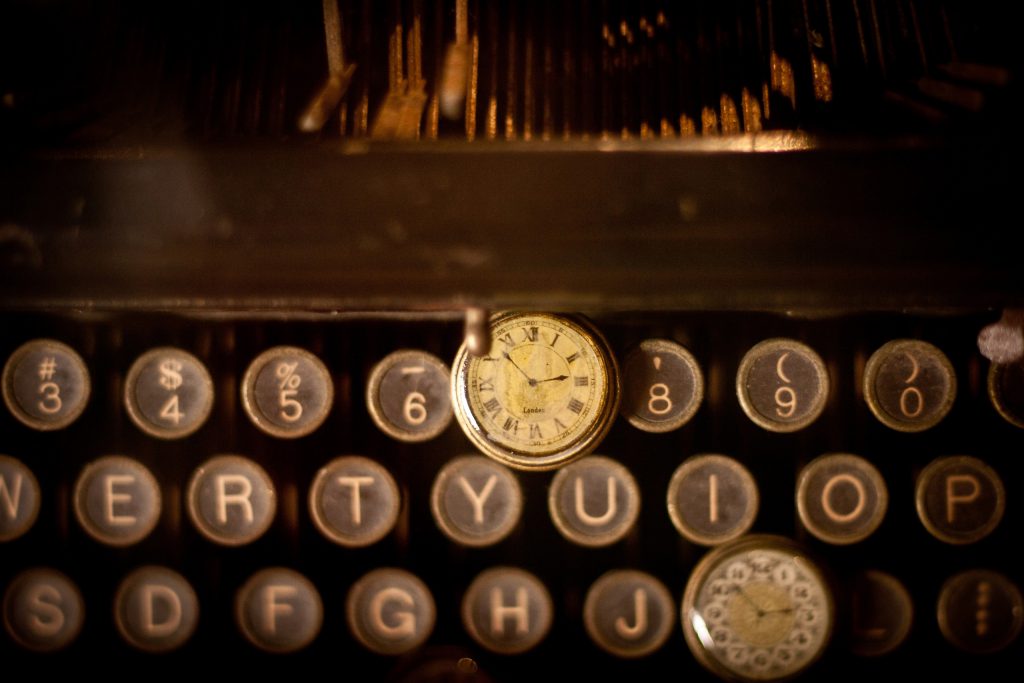 image of an antique typewriter keyboard and watch