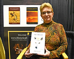 photo of Marnie Sluman Somers holding newly lauched book, "The Amulet"