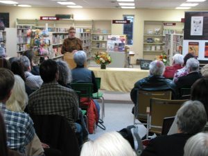 photo of guests at book launch at the Carberry Library with Marnie Sluman Somers reading from the book "The Amulet"