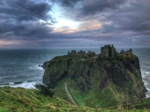 image of a ruined castle on an island with a sunset, how to use setting in your writing